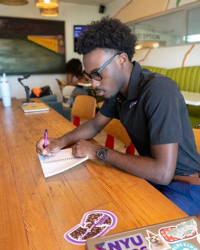 A purpose-driven student writing in a notebook